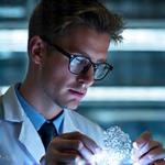 Dr. Alistair Finch, Technical Specialist for Luxury Gadgets, examining precision components.